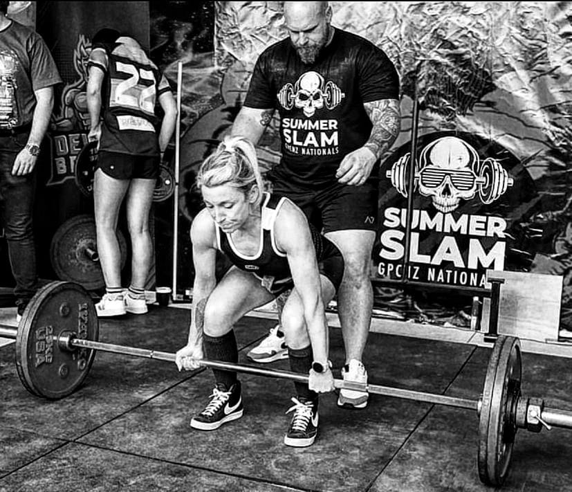 Alice deadlifting at a Powerlifting competition in 2023
