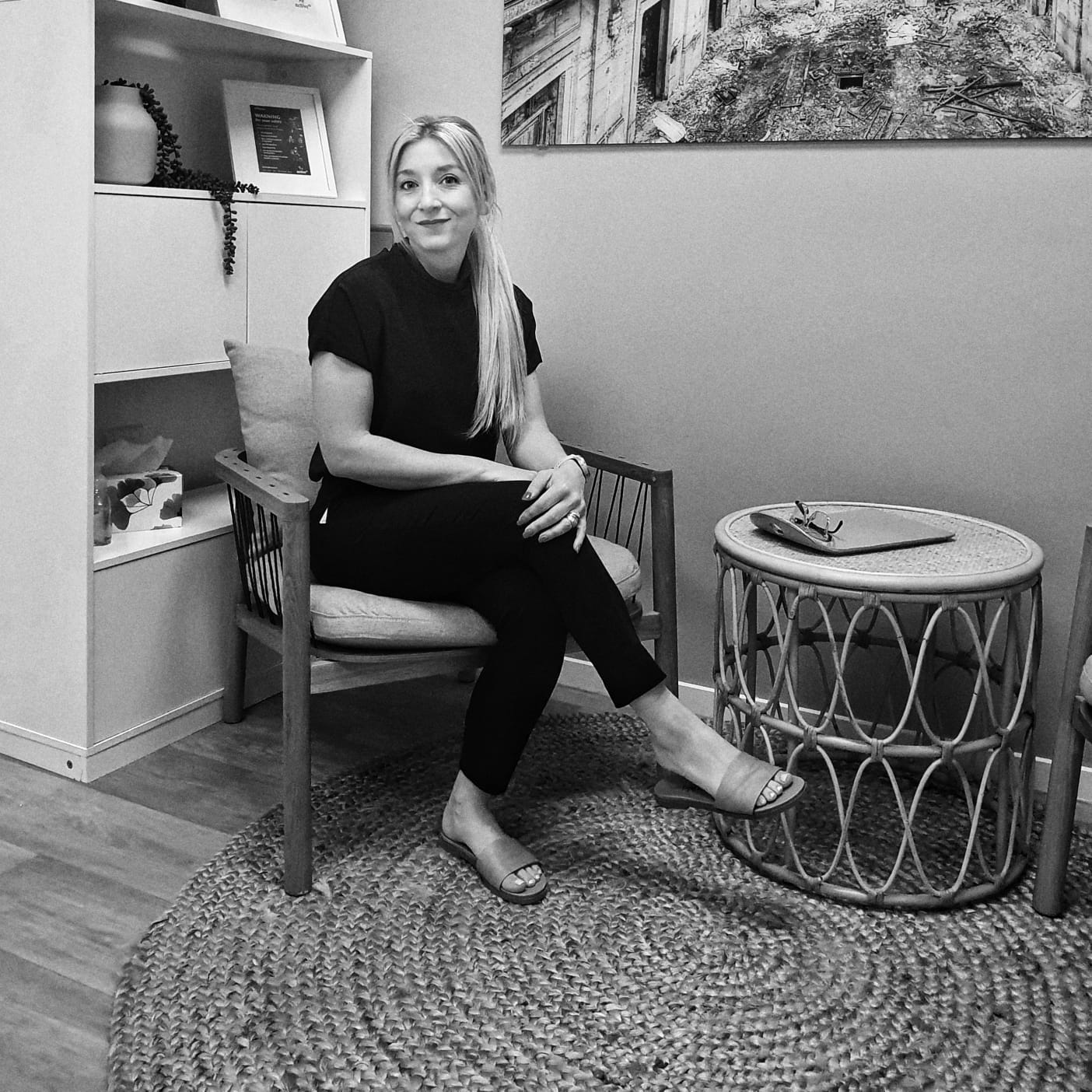 Alice sitting in a chair, smiling at the camera